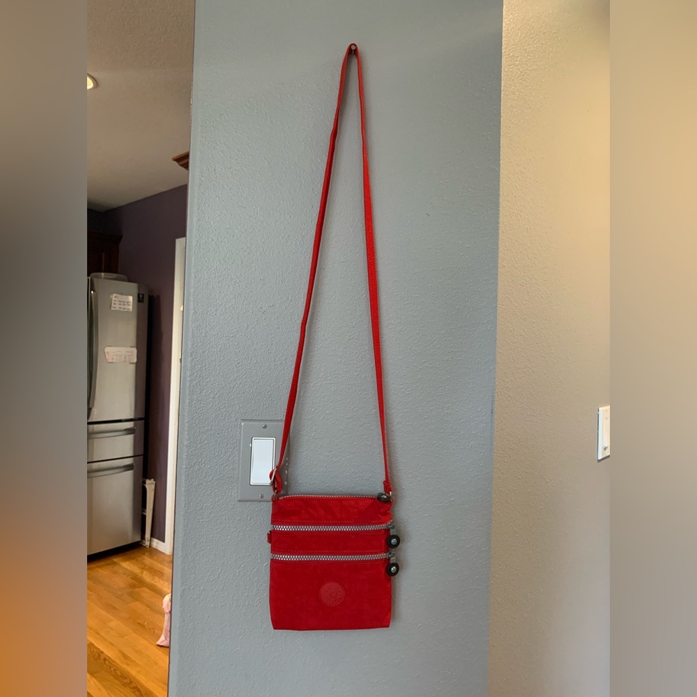 Like new true red Kipling three pocket crossbody.